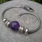 single amethyst bead with silver beads on a bracelet