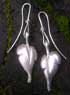 a pair of chunky silver leaf earrings