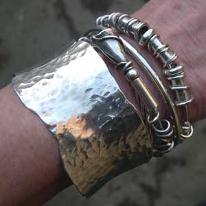 silver expanding bangles being worn with a cuff