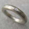 Chunky white gold eternity ring with a single diamond