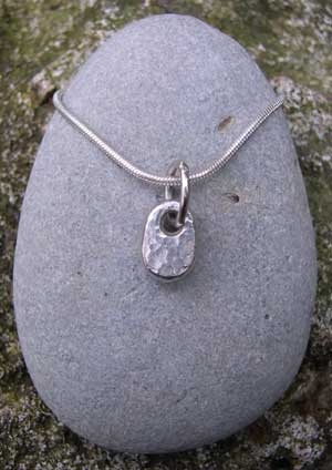 Small silver pebble on a chain