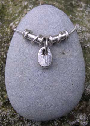Small silver pebble with 2 twist beads