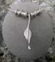 Small silver leaf pendant with 2 twist beads