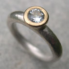 silver engagement ring with topaz set in gold top