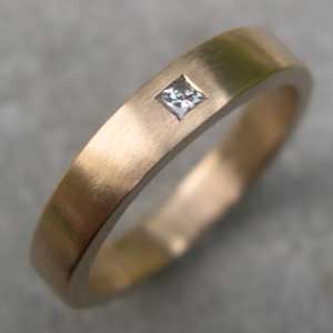 Yellow gold engagement ring with one square diamond