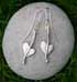 a pair of silver heart earrings