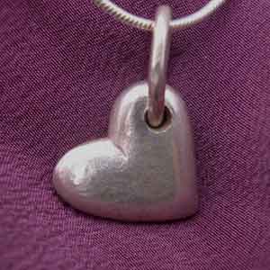 a chunky silver heart pendant on a chain