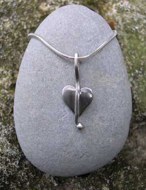 small silver heart pendant on a snake chain