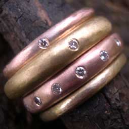 Four handmade red and yellow gold rings