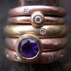 stack of rings with Amethyst and Diamonds in Red and Yellow Golds